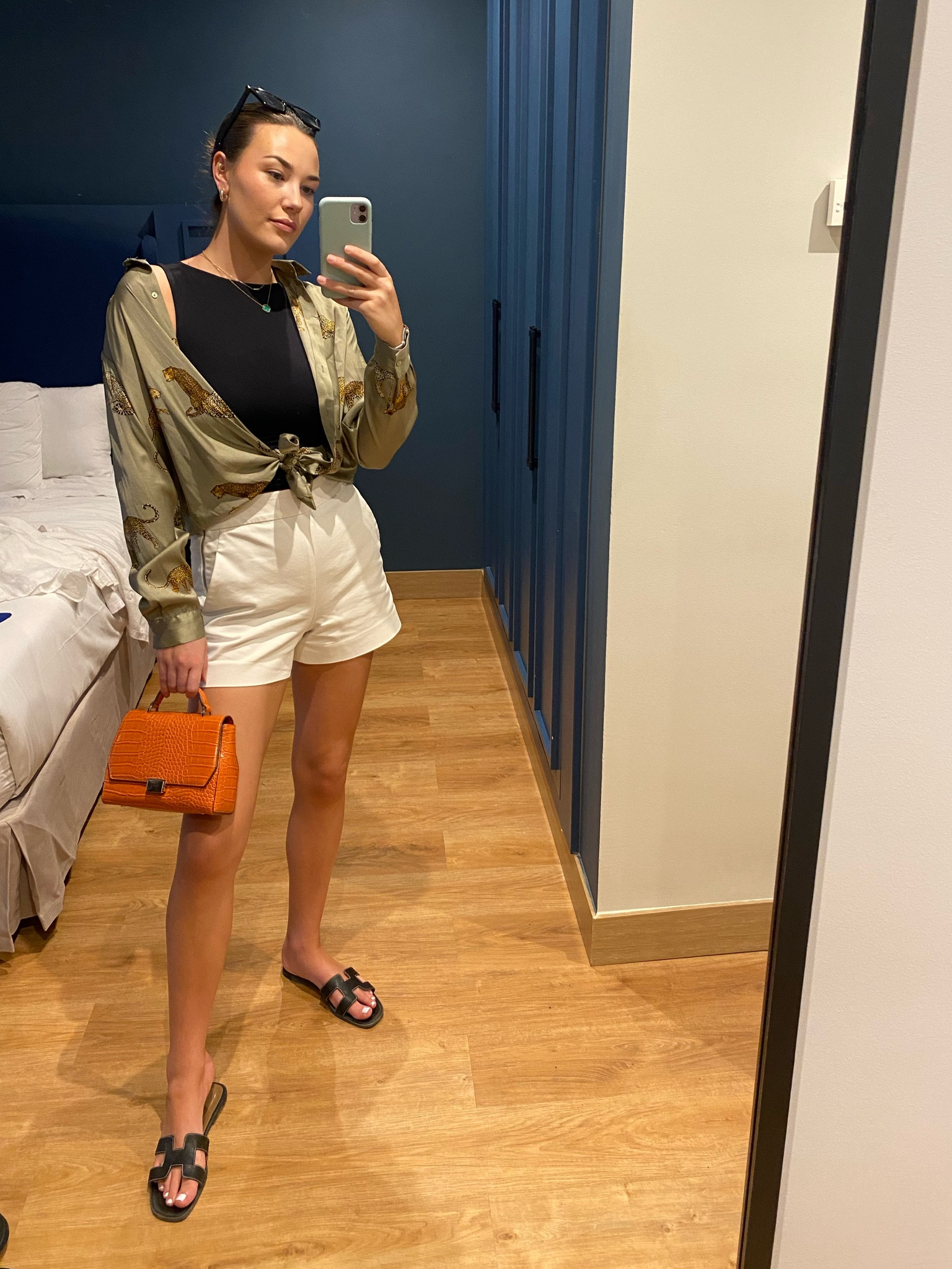 Summer outfit - white shorts, black top, Hermes Oran sandals, silk khaki shirt and orange bag.