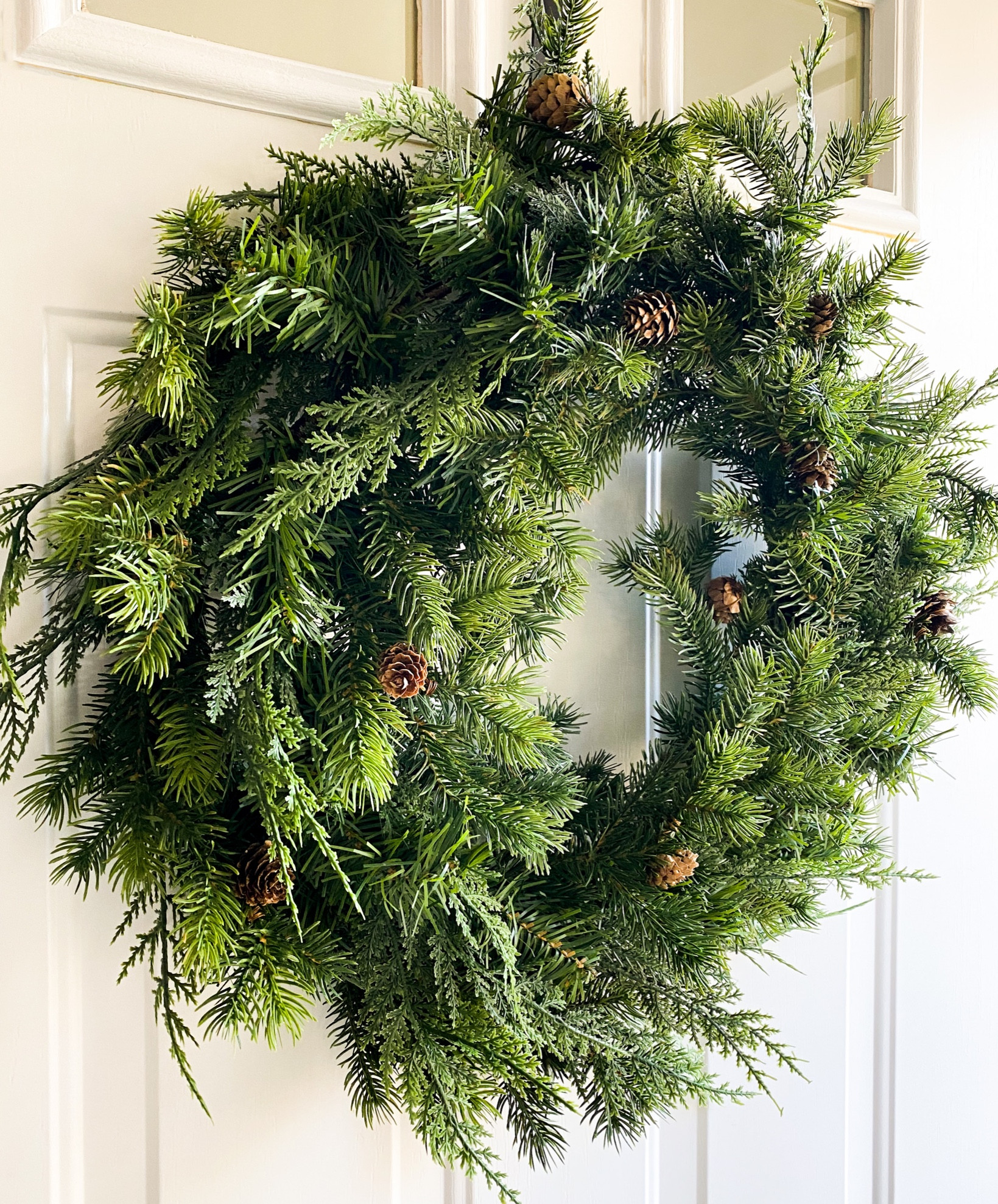 Mixed green holiday wreath for $20! Cypress wreath, 24” wreath. Beautiful and full wreath, all it needs is an added ribbon for a beautiful neutral Christmas 

#LTKhome #LTKHoliday #LTKsalealert