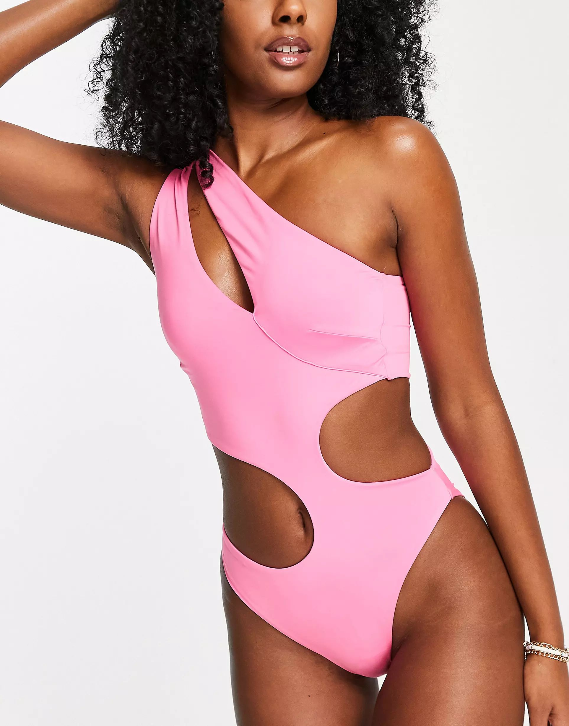 ASOS DESIGN asymmetric strappy one shoulder cut out swimsuit in neon pink | ASOS (Global)