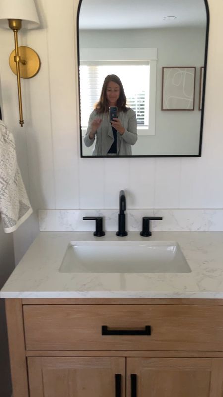 Gorgeous client bathroom vanity on an affordable budget!  

Bathroom 72” double vanity.  Black faucets.  Delta bathroom faucet.  Black arched mirror.  Brass sconce.  Modern bathroom.  

#LTKVideo #LTKHome #LTKFamily
