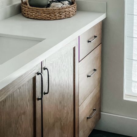 Timeless bathroom design. Black pulls in wood cabinets with white countertops. You can’t go wrong. 

#LTKstyletip #LTKhome #LTKfindsunder50