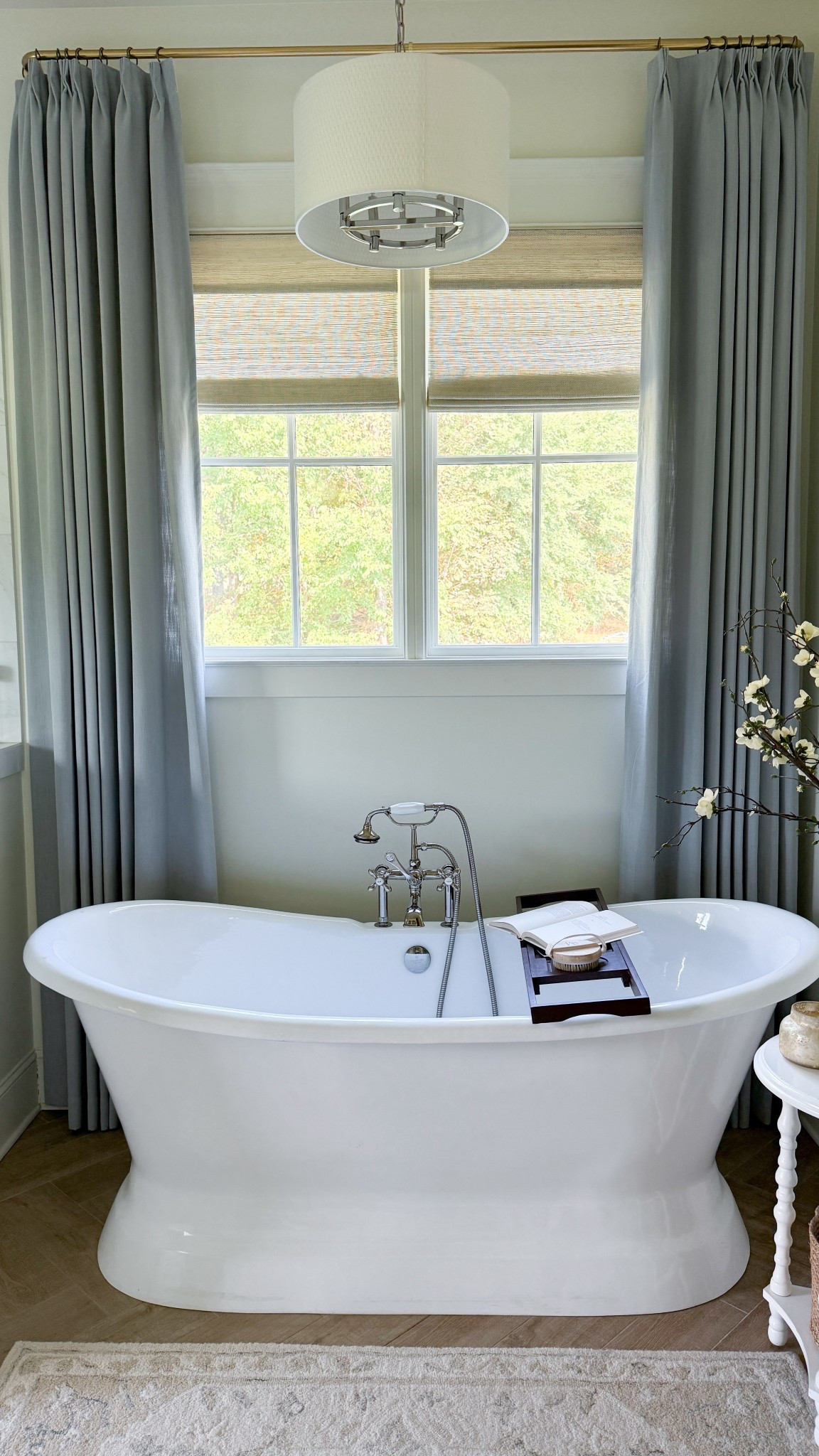 Still not over the transformation these additions made in our bathroom! 💙 The light blue curtains instantly elevated the look, while the remote-controlled bamboo shades completely changed the function of the space. No more crawling into the tub to open and close them—it’s all at the push of a button now 🙌

✨ Curtain Details: Isabella Curtains in Winter Sky with triple pleats, privacy lining, and memory-shaped design.
✨ Shade Details: Bamboo Shades in White Wall with motorization.

Both are from @TwoPages and together they brought in just the right touch of color while keeping that light & airy aesthetic I love.

(P.S. Our bathtub and plumbing fixtures have been discontinued, but I’ll link similar options for you!)

#LTKHome
