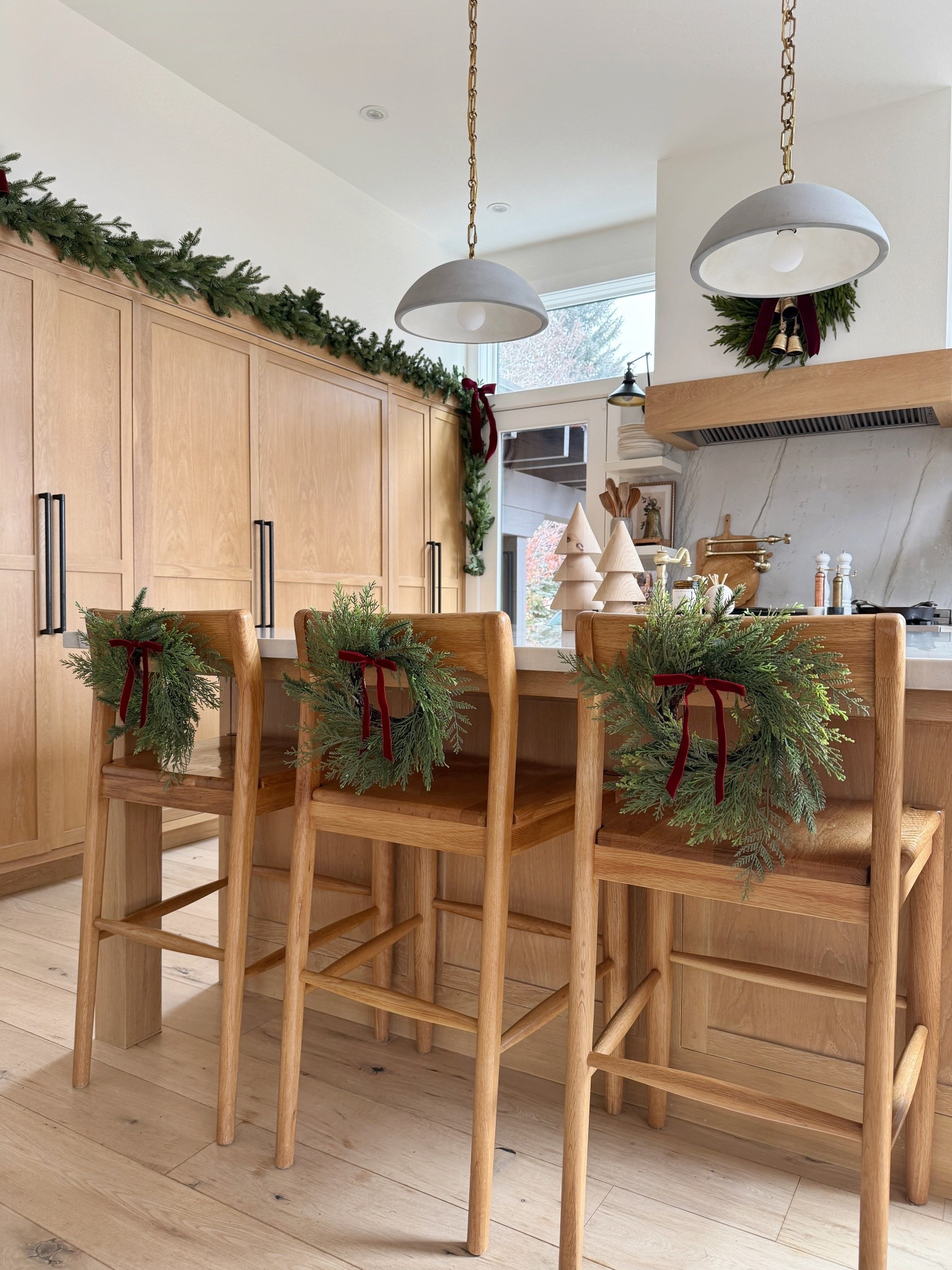 Mini 12” holiday wreaths styled in my barstools using a command hook. Linking a bunch of different small wreath options and what i used here! 

Christmas 
Home decor
Kitchen 

#LTKHome #LTKHoliday