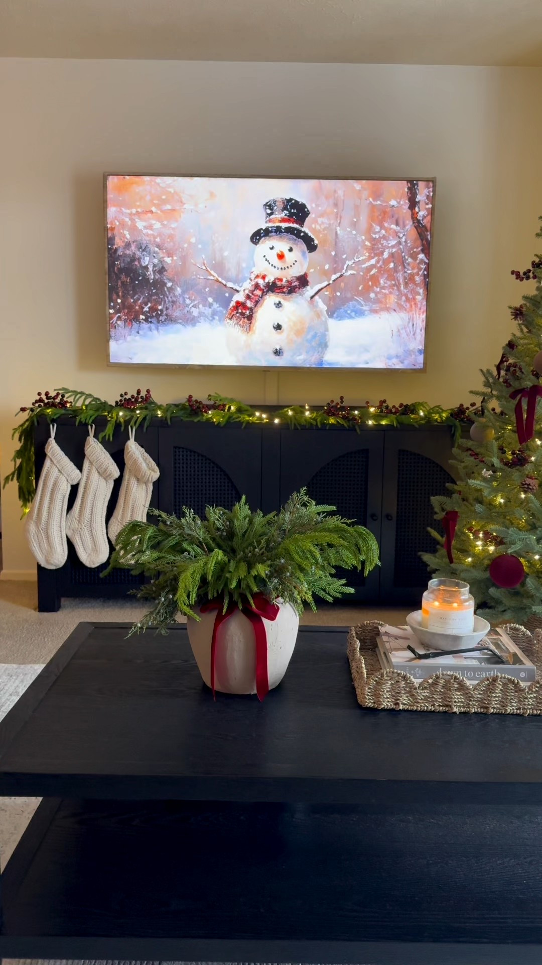 Black sideboard, lulu and Georgia, wayfair, black console, black arch cabinet, tv stand, Norfolk garland, led lights, balsam hill tree, brass bow, tree skirt, beige vase, Norfolk pine stems, twinkle lights, basket, tray, red ribbon, cream stockings, burgundy ornaments, berry stems, brown ornaments

#LTKHoliday #LTKHome #LTKSeasonal