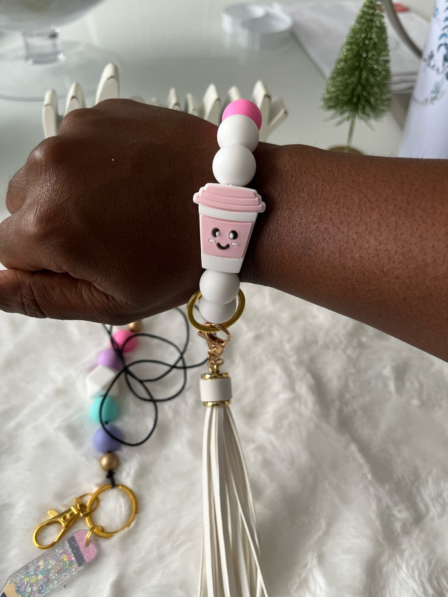 This white and pink bracelet is both cute and functional! It easily attaches both your keys and wallet to your wristband. The coffee cup detail adds a nice touch!
#giftideasforteachers #lanyardlovebirds #affordablegifts #coffeelover

#LTKstyletip #LTKGiftGuide