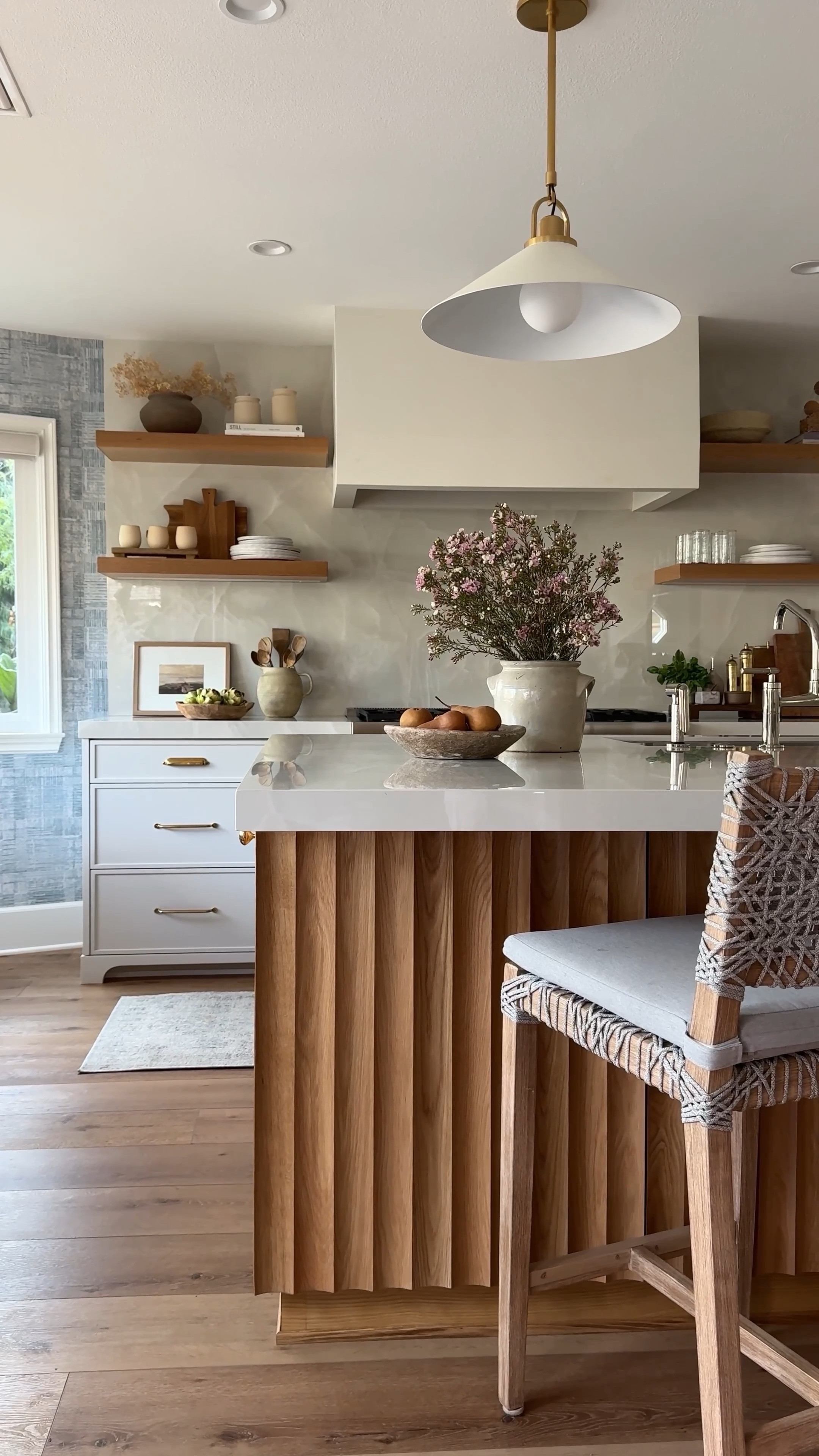 The number one question I get asked about our client's kitchen is the wood detail on the island. This is a custom design we did but I found one that looks exactly the same and more affordable!
It should be an easier install too because it comes in sheets. You can also stain it or paint it. This would look beautiful as a backing to a bookshelf or vanity. 

Fluted wood Rattan chair white pendant light 

#LTKFindsUnder100 #LTKHome #LTKSaleAlert