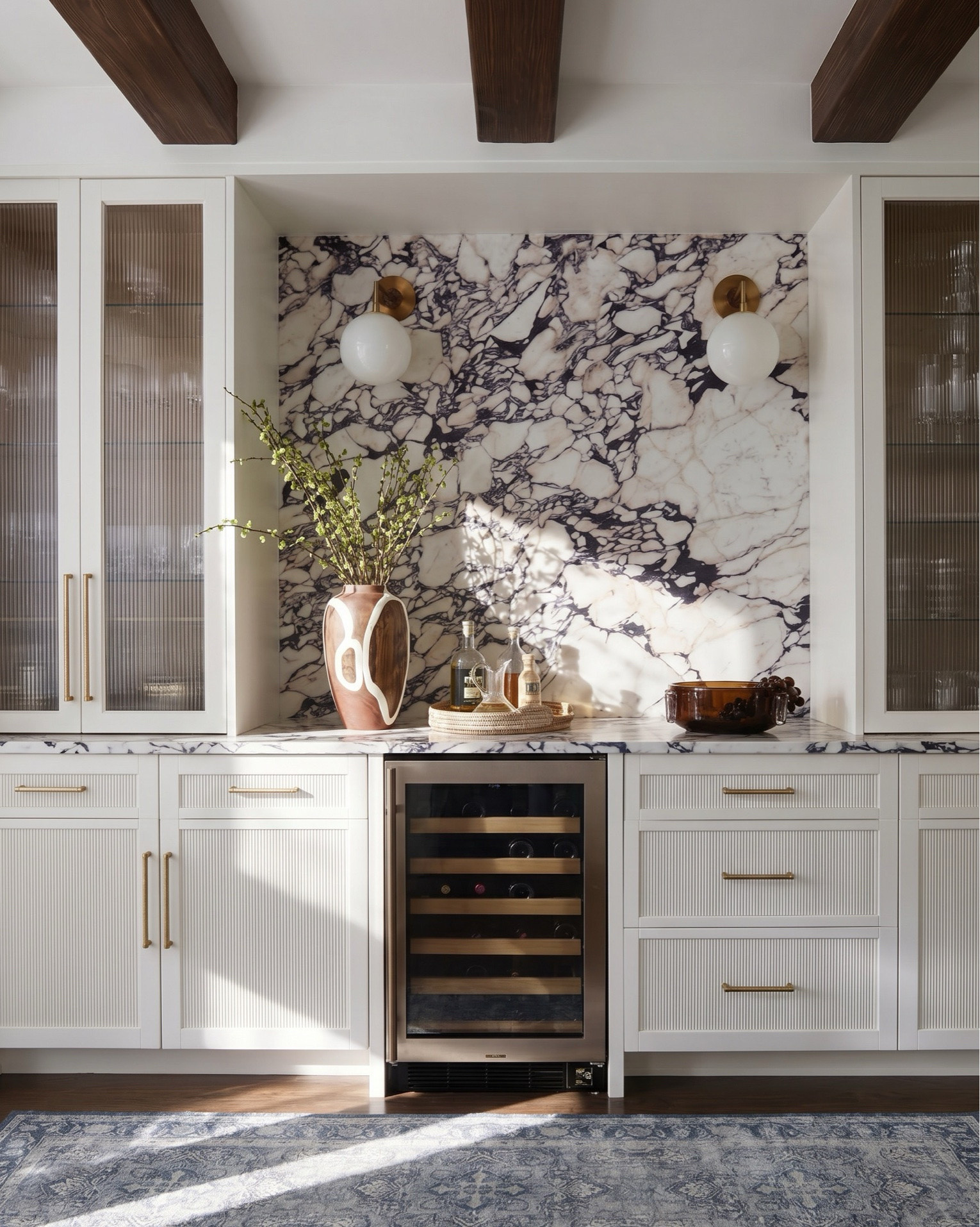 Layered transitional living room inspiration with luxe marble fireplaces, moody floral wallpaper, dark wood beams, boucle accent chairs, and designer lighting details. Shop the look for a cozy modern organic home with high-end furniture, neutral decor, blue accents, brass lighting, textured rugs, and timeless statement pieces. Perfect inspiration for anyone searching for transitional style living rooms, modern farmhouse decor, marble fireplace ideas, designer coffee tables, and curated home accessories. 

Shop this space: • Marble fireplace surround • Dark wood ceiling beams • Brass chandelier lighting • Boucle accent chairs • White slipcovered sofa • Blue patterned throw pillows • Dark wood coffee table • Abstract framed artwork • Textured neutral area rug • Ceramic table lamps • Built-in shelving decor • Decorative woven baskets • Floral wallpaper mural • Fringe ottomans • Fluted console table • Brass wall sconces • Ribbed cabinetry details • Marble slab backsplash • Glass cabinet fronts • Wine fridge built-in • Blue and cream vintage style rug • Modern ceramic vases • Coffee table styling books • Neutral cozy throw blankets

#LTKsale #LTKhome #LTKstyletip