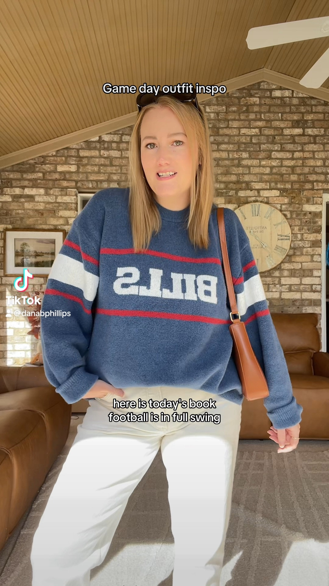 Football game outfit inspo. Buffalo bills sweater, white jeans, cream jeans, black oval sunglasses, brown shoulder bag, Birkenstock clogs. Easy casual fall outfit  

#LTKStyleTip #LTKMidsize #LTKFindsUnder100