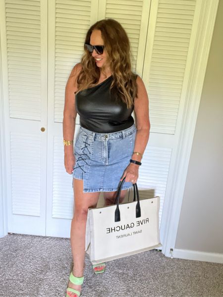 A faux leather one shoulder body suit is a fun Summer look with a denim skirt/shorts. It is lightweight and easy to style. I added fun green sandals for a pop of color. 

#LTKMidsize #LTKFindsUnder50 #LTKShoeCrush