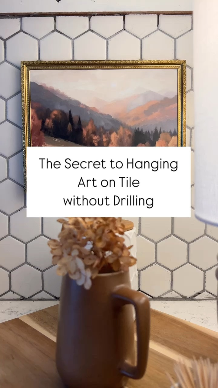 Tired of struggling to hang art on tile without drilling? I've got the perfect hack for you! 🙌 Just use double-sided tape and apply it on each corner of your frame. No mess, no damage, and your art stays securely in place! 🖼️✨

Fall decor.
Fall art.

#LTKHome #LTKVideo