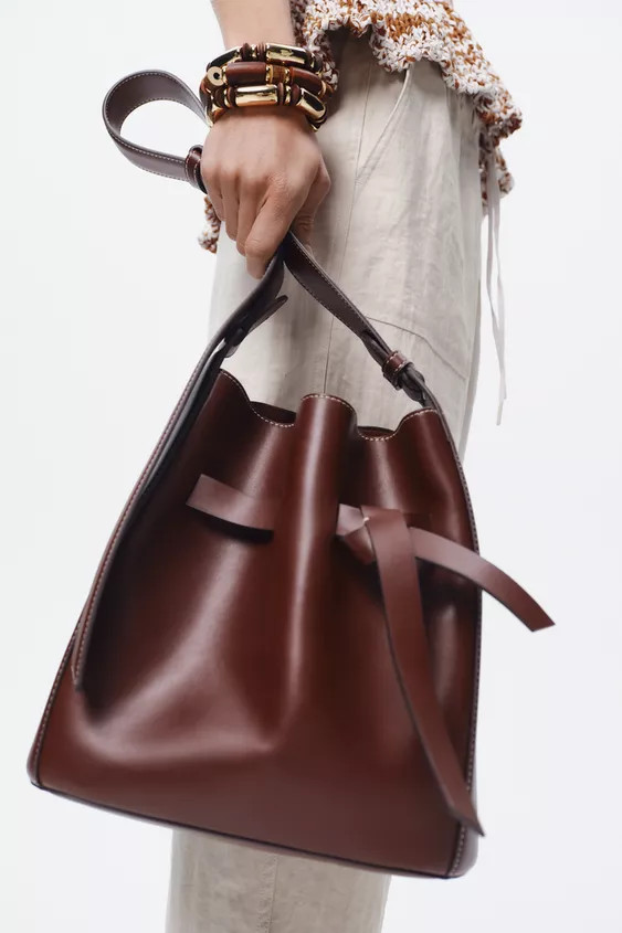 Bucket bag with knotted strap detail on the body. Contrast topstitching. Adjustable shoulder stra... | Zara US