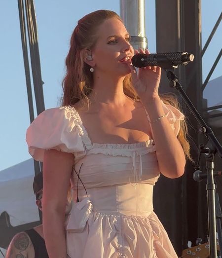 Shop Lana Del Rey's pink colored cotton maxi dress with puff sleeves pleats and laced details drawstrings to bustle the front skirt corset back pink cowboy boots #LanaDelRey #CelebrityStyle



#LTKFestival #LTKStyleTip #LTKShoeCrush