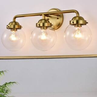 3 Light Antique Brass Vanity Light with Globe Clear Glass Shade | The Home Depot