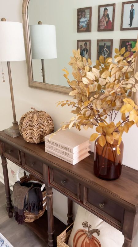 Fall entryway table decor. Amber glass vase, woven pumpkin, neutral stacked books, buffet lamp 

#LTKhome #LTKSeasonal
