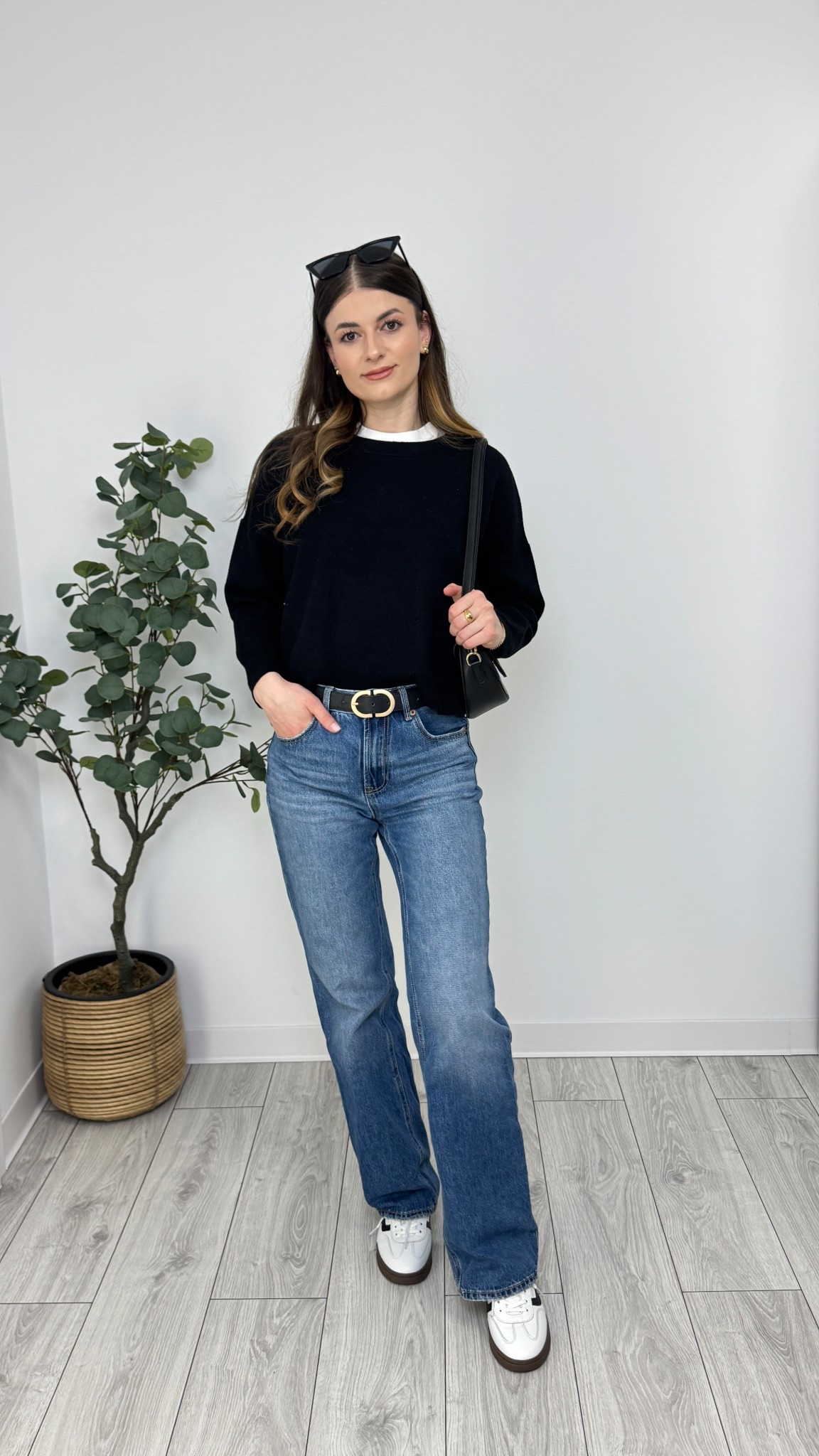 A sleek black jumper over a white tee, styled with blue wide-leg jeans. Finished with white sneakers, a black belt, and a structured bag for a refined yet easygoing look 🖤 #IlaStylesDiary 

#LTKeurope #LTKspring #LTKworkwear