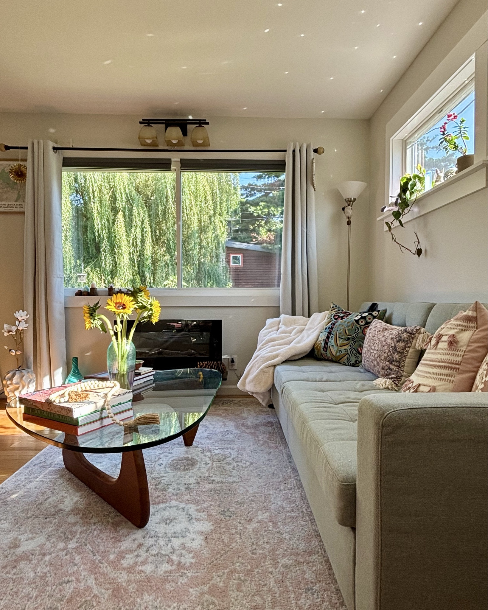 Sunflower vibes at home! 🌻Rearranged the furniture a bit, still loving my Noguchi-style coffee table and this electric fireplace! #homedecor #livingroominspo #livingroomdesign 

#LTKFamily #LTKStyleTip #LTKHome