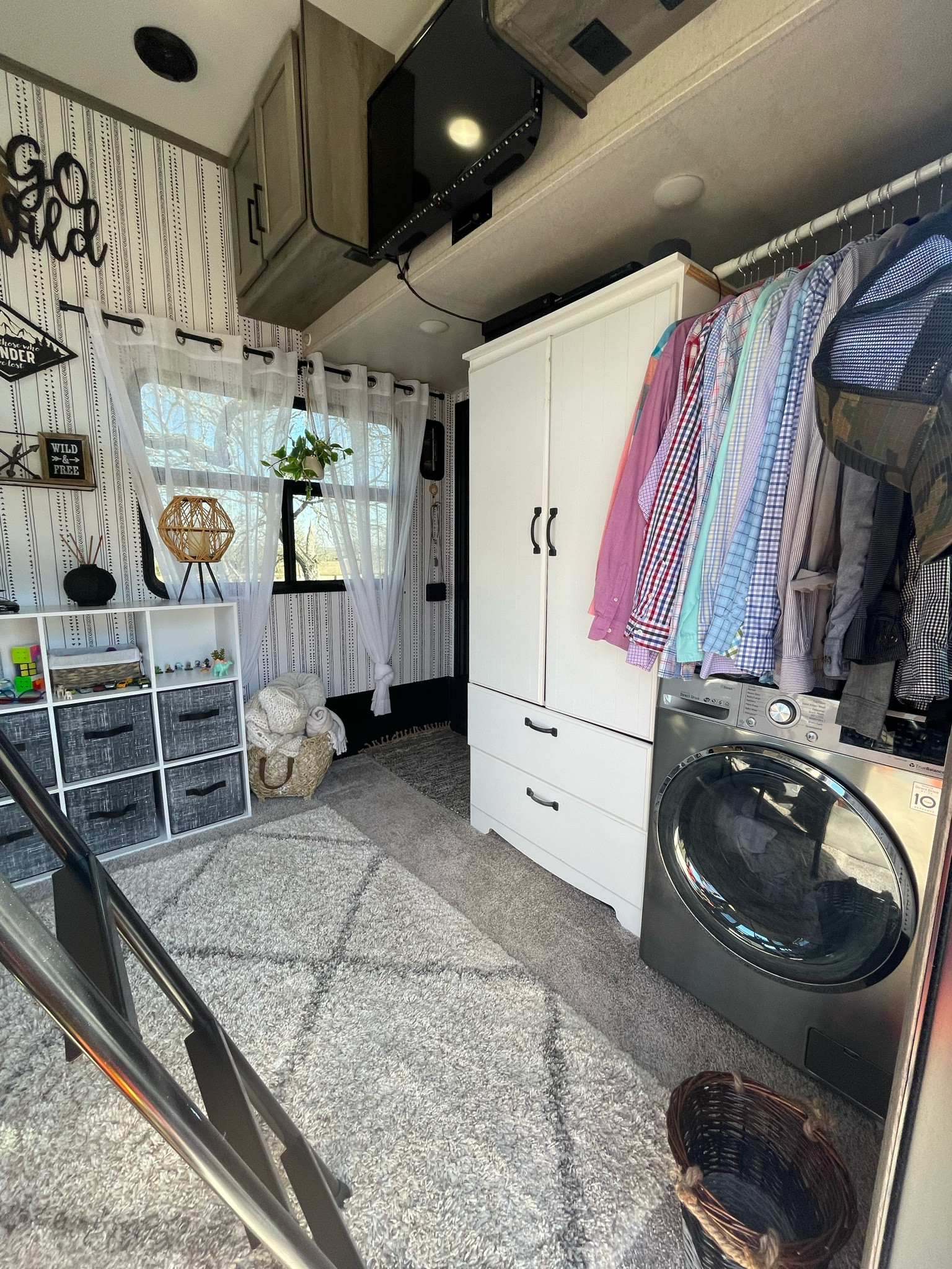 Toyhauler RV kids bedroom! 
I added some fun, wallpaper, sheer curtains, a Cube bin organizer and cube bins, an area carpet, a dresser and washer dryer combo to the space. 

#LTKhome #LTKfamily #LTKstyletip