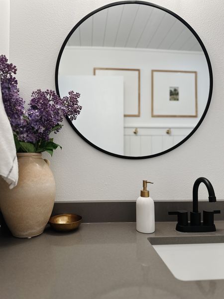 Wood picture frame,state black faucet, terracotta vase, afloral faux lilacs, brass towel hooks, shiplap bathroom, white and grey striped hand towel, grey quartz countertop, brass decor dish, black round mirror, brass and white soap dispenser, home decor, Amazon find, target find, studio McGee home decor 

#LTKhome #LTKstyletip #LTKFind