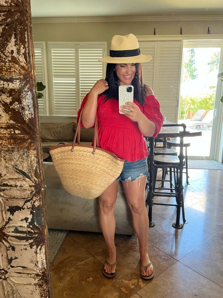Fourth of July fit! Straw hat, straw bag, flip flops, Jean shorts, and red top. 
My new shorts are fantastic! Perfect amount of stretch, comfy and flattering. They come in several washes and are on sale. For reference I’m wearing a small. 

#LTKsalealert #LTKFind #LTKSeasonal