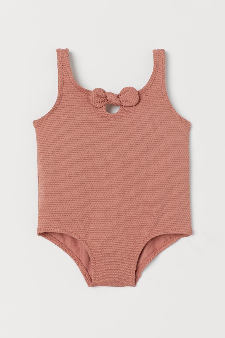 Baby Exclusive. Fully lined swimsuit in textured fabric. Small opening at neckline with a decorat... | H&M (US + CA)