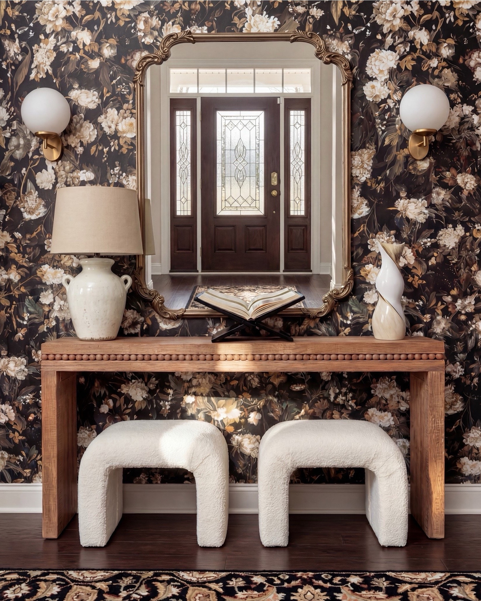 Shop the Look:
• Floral wallpaper (taupe, mauve, soft brown tones)
• Walnut wood bed with brass corner accents
• Cream duvet with layered neutral bedding
• Caramel + rust throw pillows
• Black lumbar pillow (matte leather look)
• Chunky caramel knit throw
• White ceramic bedside lamps
• Walnut 3-drawer nightstands
• Bouclé curved stools
• Neutral vintage-style rug with soft brown pattern
• Abstract wall art (warm neutrals + charcoal

#LTKsale #LTKhome #LTKstyletip