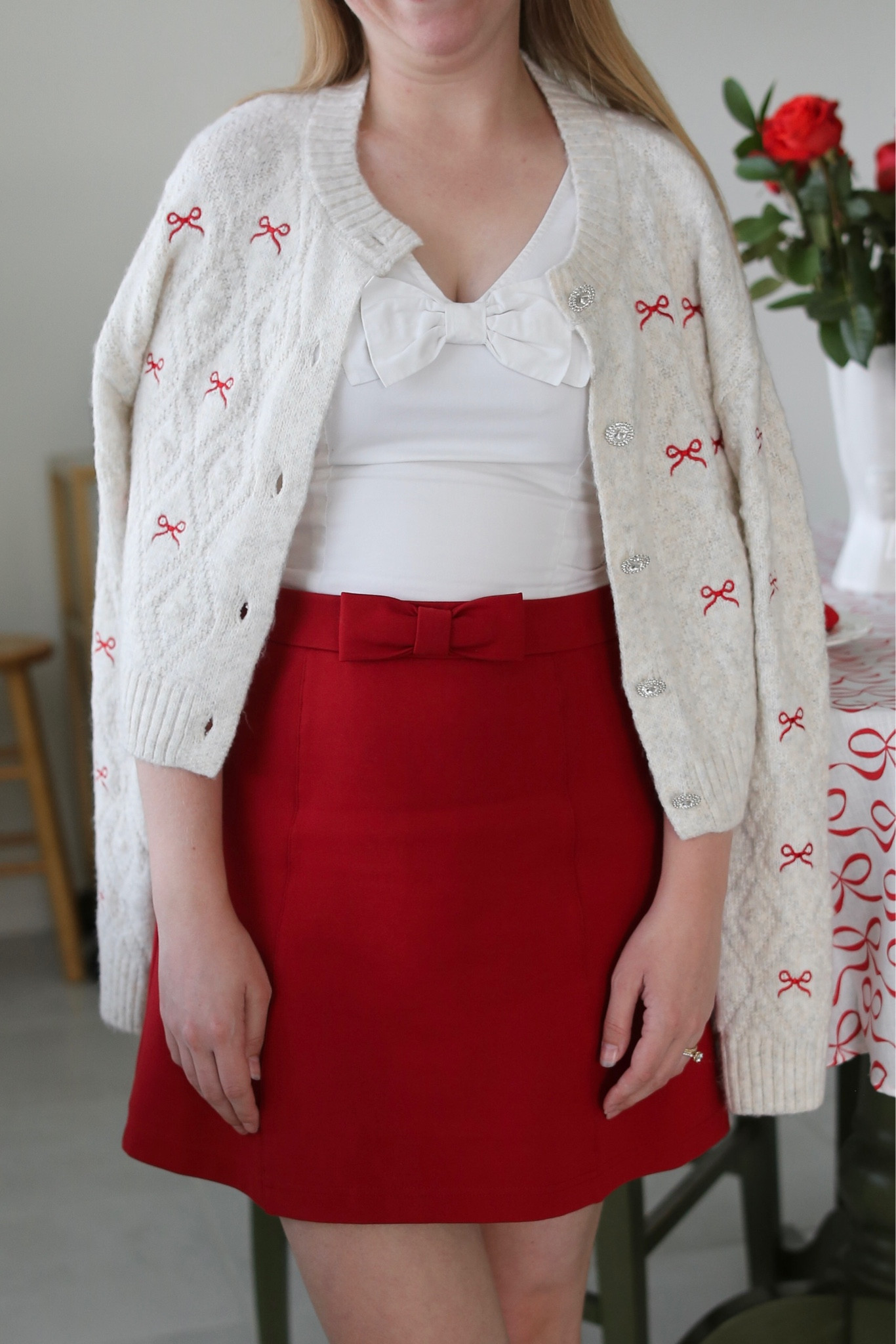 A red bow embroidered cardigan paired with a red mini skirt is the perfect Valentine’s Day outfit! 