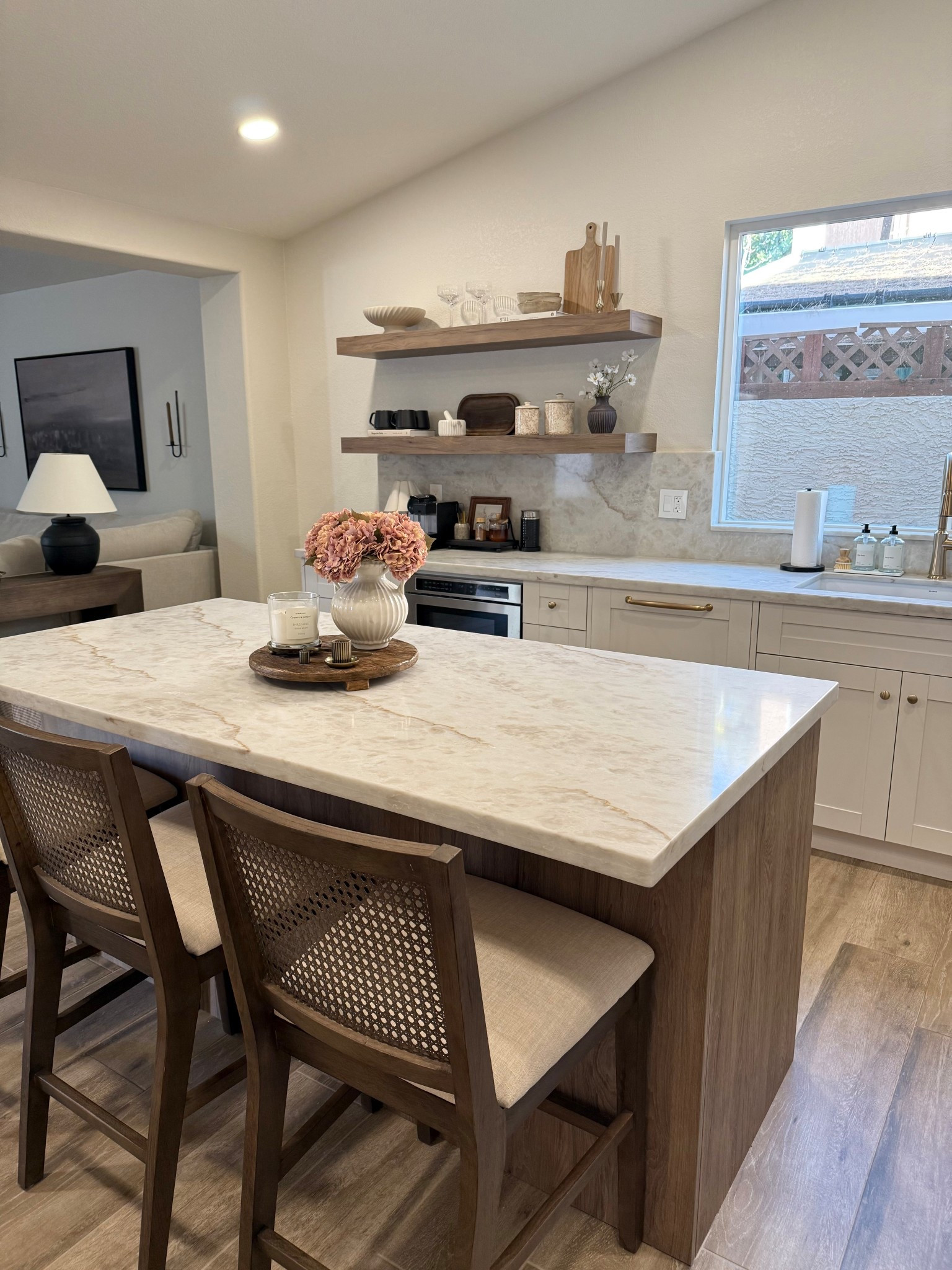 My favorite view lately😍 our finished kitchen remodel! 

I fell in love with designer stools but not the price, luckily I found this affordable alternative!! I like them even more than the designer version! 

These floating shelves are the perfect accent, matching our island! 
•
•
Kitchen remodel, Taj Mahal counters, warm kitchen design, cream and wood cabinets, champagne bronze, gold kitchen, cabinet hardware, delta champagne bronze, Amerock hardware, pottery barn dupe, dark brown cane stools, counter stools, wood counter stools, cane stools 




#LTKFindsUnder100 #LTKHome #LTKFindsUnder50