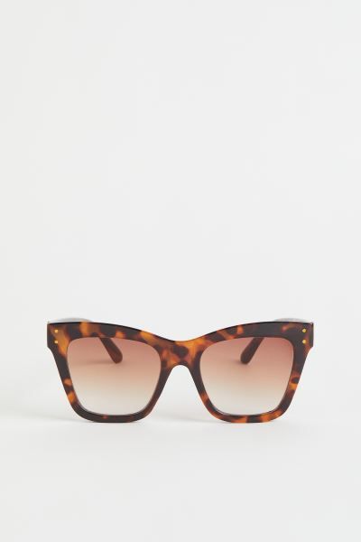 Large, cat-eye sunglasses with frames, lenses, and sidepieces in plastic. Tinted, UV-protective l... | H&M (US + CA)