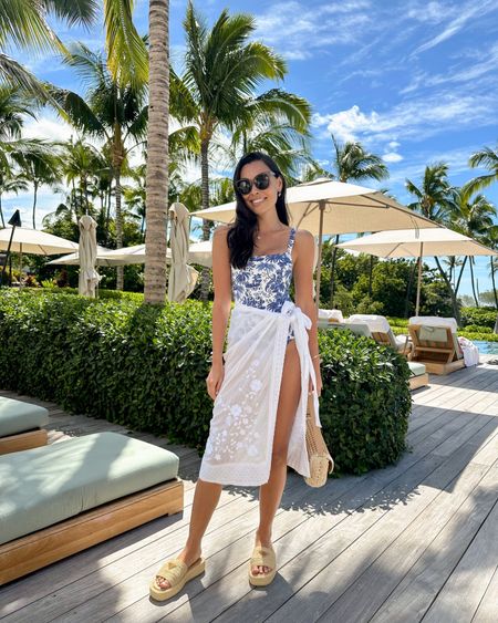 Kat Jamieson wears a blue and white swimsuit and white sarong. What to wear in Hawaii, vacation outfit, spring outfit, Prada raffia sandals, poolside, swim, swimwear, bathing suit, Staud. 

#LTKSeasonal #LTKswim #LTKtravel