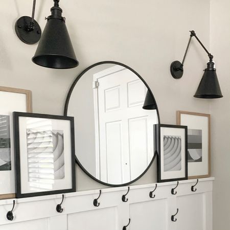 Entry way with a round mirror, wall sconces, picture frames, coat hooks, and more! 

#LTKunder100 #LTKunder50 #LTKhome