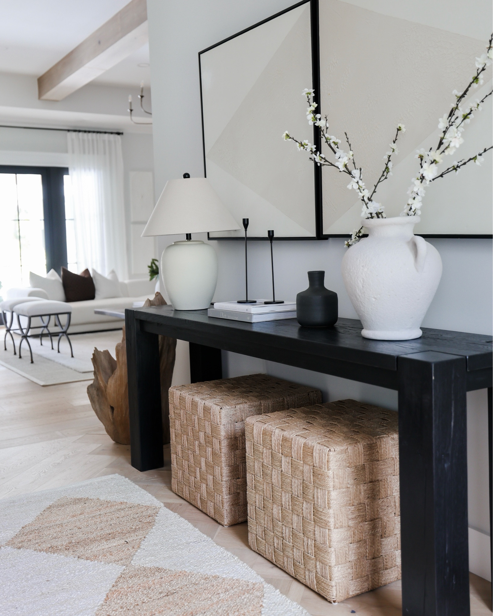 Entryway styling! 
Black console table, ottomans, candle holders, vase, stems, lamp, art, rug