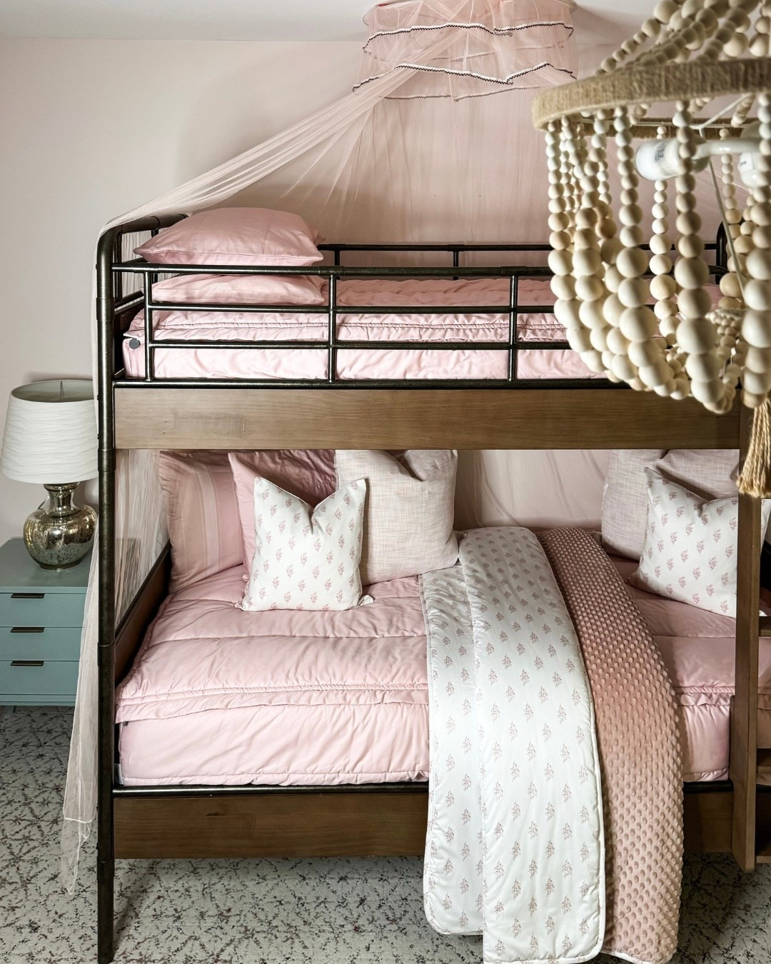 A dreamy hideaway 🌿 From the metal bunk bed with blush bedding and canopy to the papasan chair with plush pillows, every detail in this room speaks comfort. The tassel chandelier, patterned carpet, abstract framed art, metallic lamps, and pink curtains bring texture + personality to the space. Perfect for both rest + play. 🌸
#InteriorInspo #BunkBedDecor #PinkBeddingStyle #PapasanSeating #ChandelierGoals #PatternedCarpet #WallArtDecor #KidsRoomStyle #eanesinteriors



#LTKdayinmylife #LTKFindsUnder100 #LTKHome