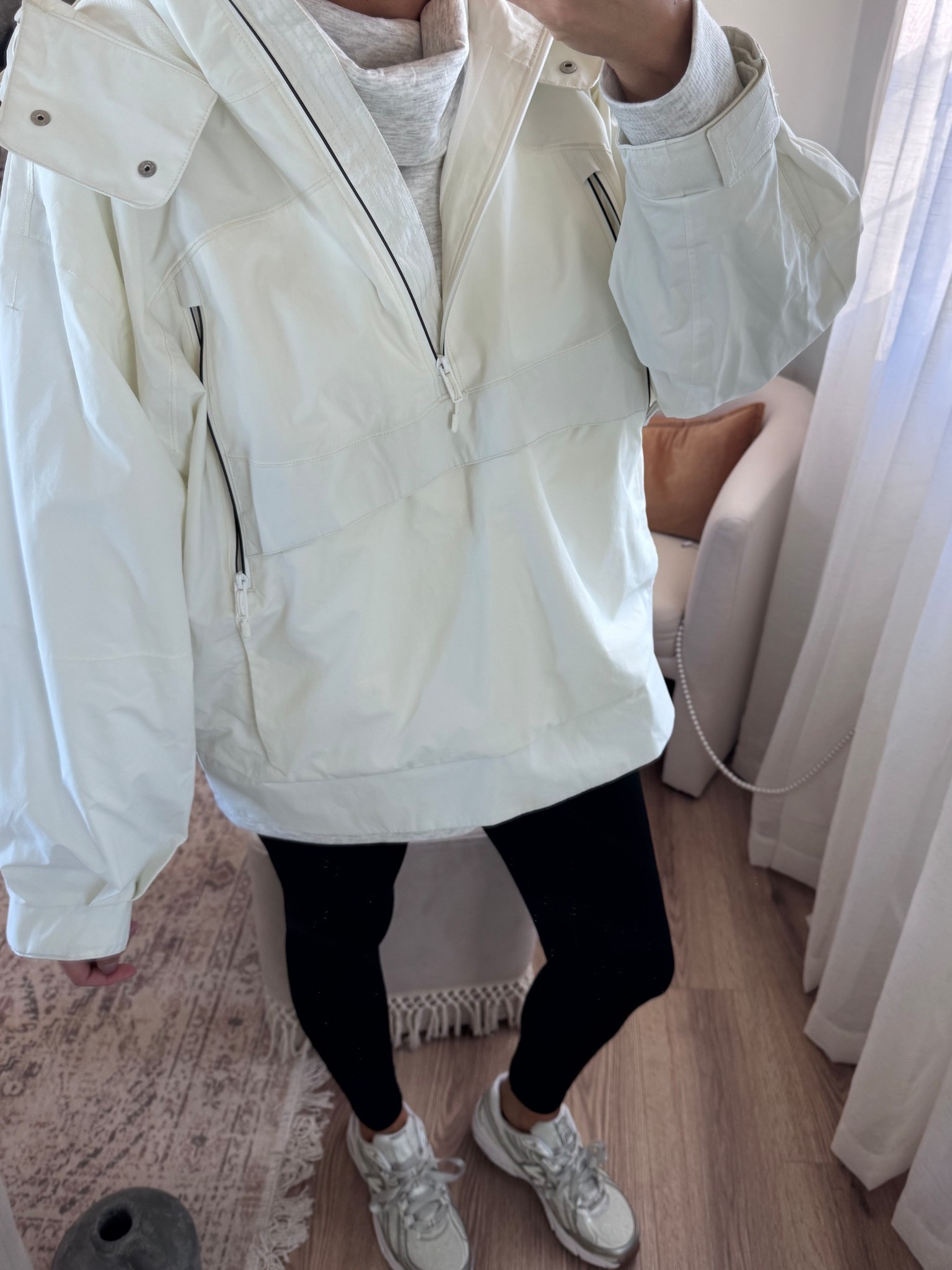 White raincoat. Lace new balance sneakers.