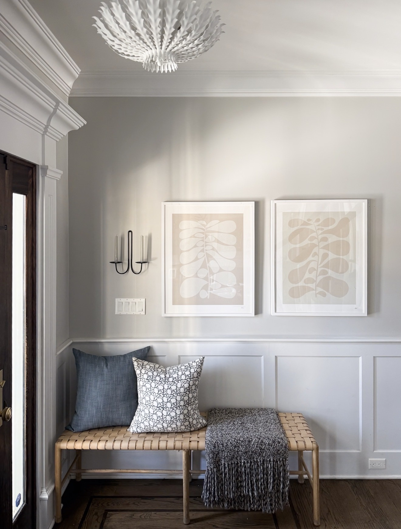 This entryway blends classic architectural details with relaxed coastal textures. A woven bench, soft pillows, and warm wood accents help create a welcoming first impression. Neutral paint colors keep the space feeling bright and timeless.

neutral entryway decor, woven bench styling, coastal entryway design, light gray wall paint, Benjamin Moore Misty Gray, foyer styling inspiration, modern traditional entryway, layered neutral decor, welcoming entryway ideas, classic home interiors, entryway inspiration, girlonthehudson

#LTKHome