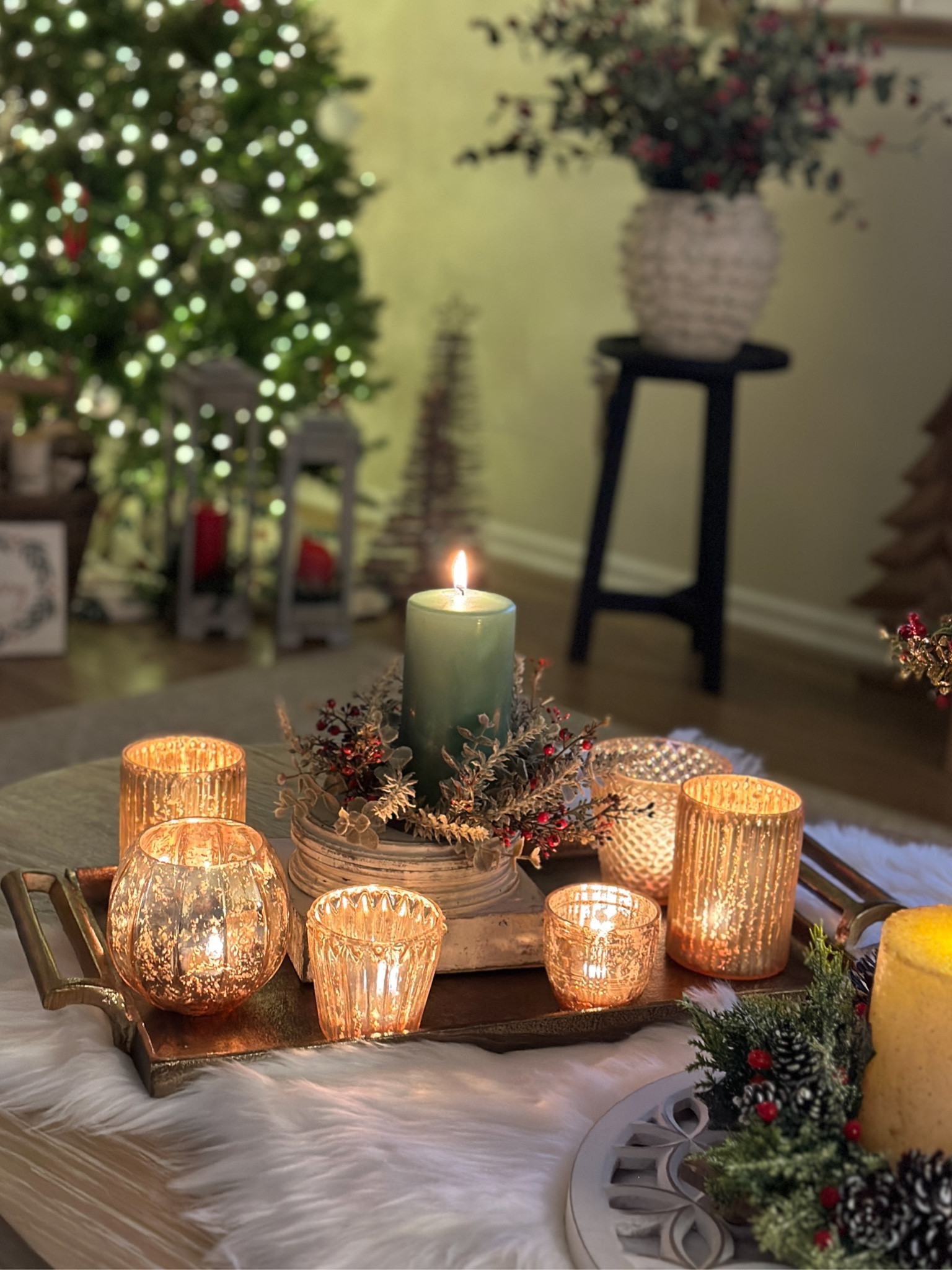 Currently on sale - beautiful votive candle holders in varying styles and finishes. Christmas candlelight tray display. Antiqued metal gold rectangular tray. Green pillar candles. Faux fur that I used as a table runner. 

#LTKCyberWeek #LTKHoliday #LTKSeasonal