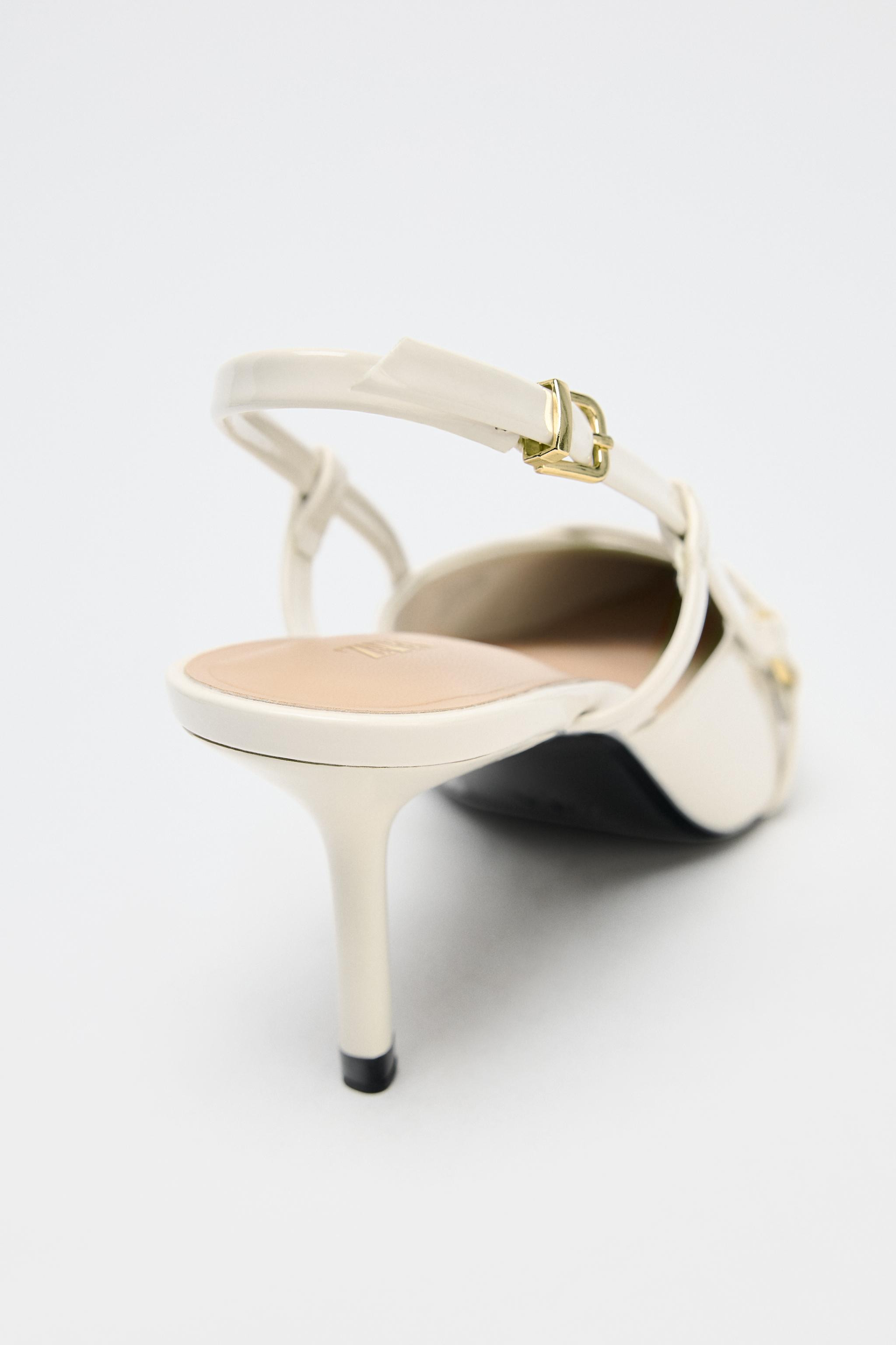Patent finish slingback heels. Strap detail with metal buckle at the front. Stiletto high heel. B... | Zara US