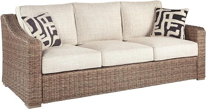Signature Design by Ashley Beachcroft Outdoor Wicker Patio Sofa with Cushion and 2 Pillows, Beige | Amazon (US)
