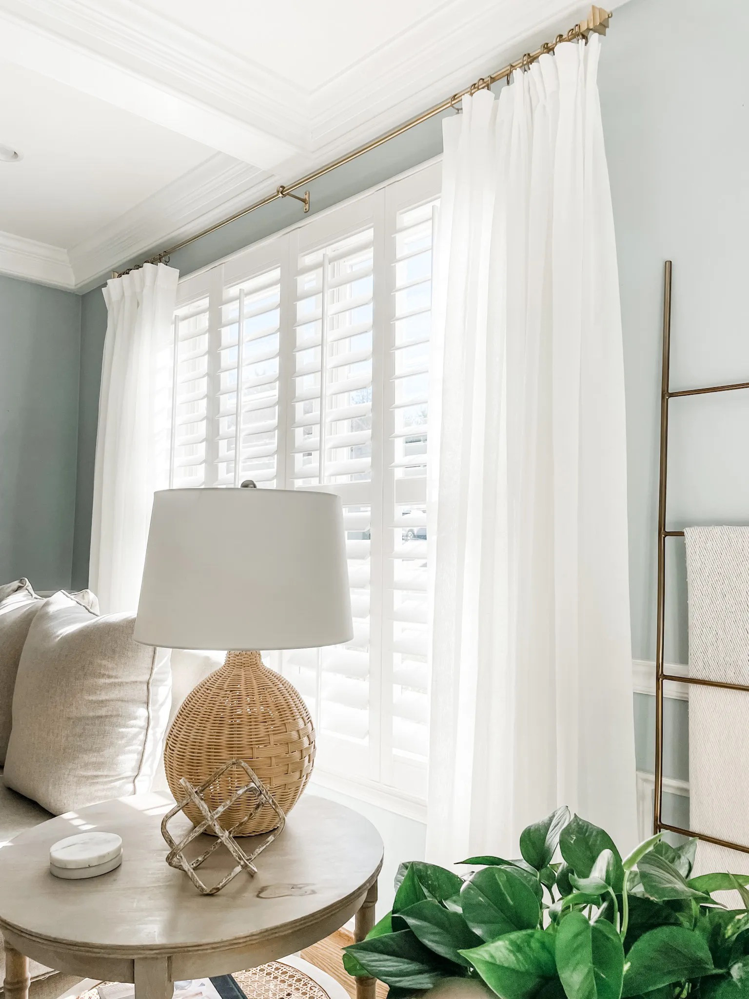 Love these pinch pleat curtains from Amazon! We have them in off white and they are the perfect window decor to frame for our indoor shutters.

Also from Amazon - wood chain link decor that comes as a set as one larger wood chain link shown on the round mango wood side table and the other strand of wood bead Garland is hanging in the entryway on our accordion wall hook.

Living room decor. 
Coastal decor, woven lamp, rattan table lamp, marble coasters, round side table with caned shelf, mango wood end table, blanket ladder,

Amazon curtains, Amazon drapes, pinch pleat drapes, faux linen curtains. Semi sheer curtains. 
#founditonamazon #amazondecor #livingroom

#LTKhome #LTKstyletip #LTKFind