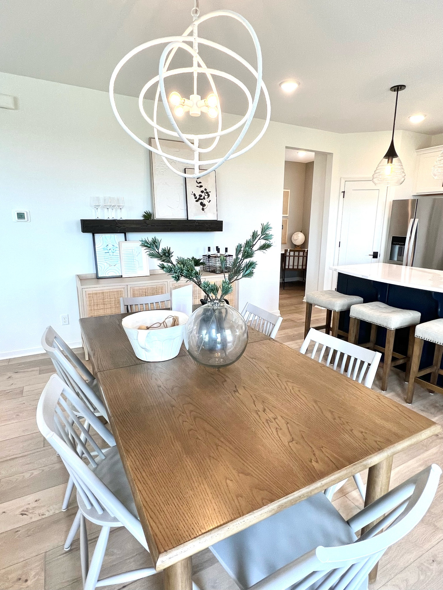 Dining room area, chandeliers, pendant lights, Buffett/ sideboards cabinet, dinning table and chairs. Barstools, plaster art.

#LTKhome #LTKstyletip #LTKsalealert