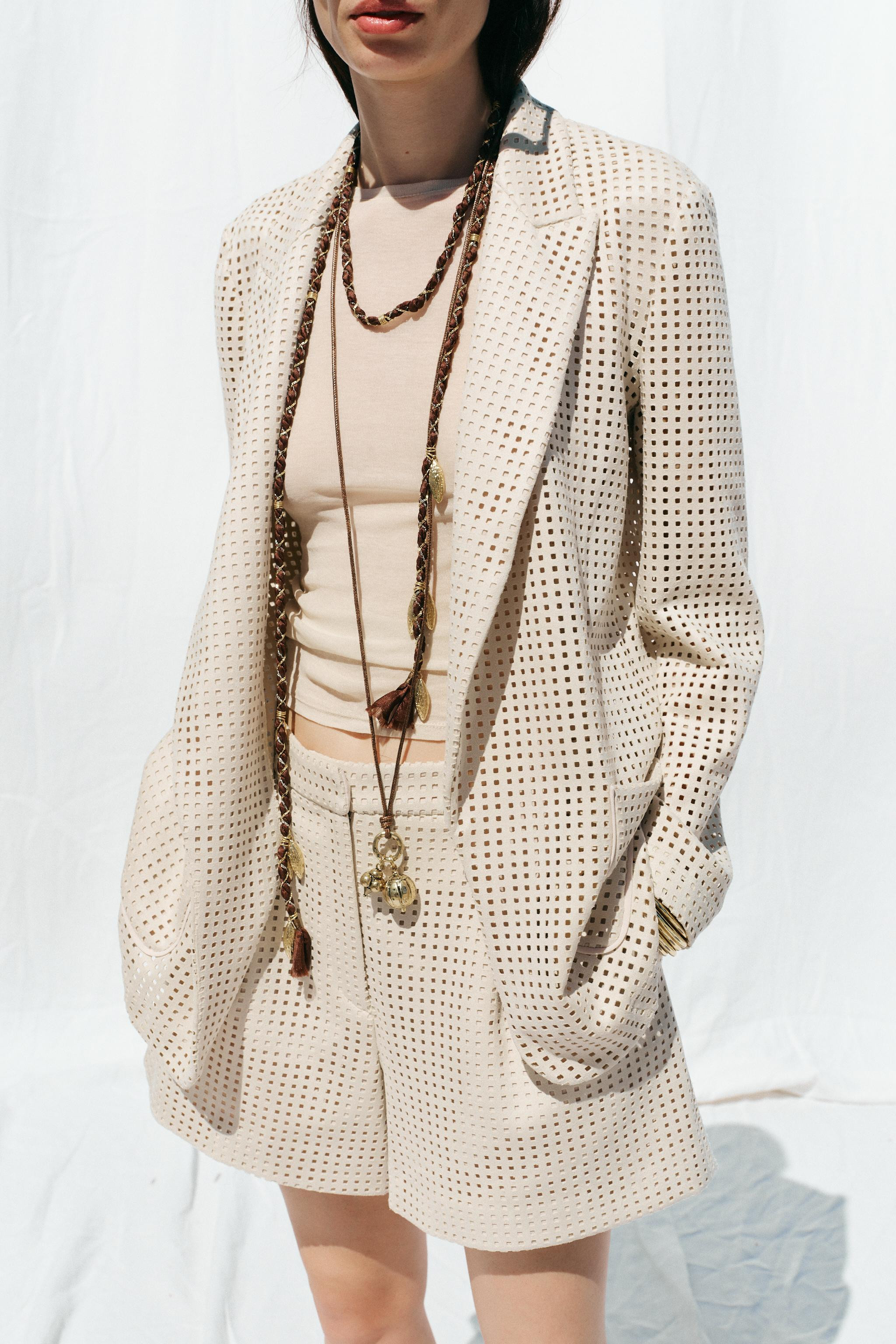 Long sleeve open blazer with a lapel collar. Fabric detail with cutouts. Front patch pockets. | Zara US