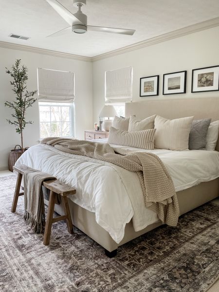 Neutral bedroom with simple accents: chunky knit blanket, slim olive tree, wood bench, framed art. 

#LTKstyletip #LTKhome