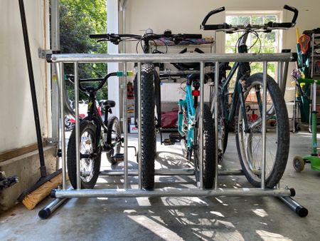 Hanging bikes on a wall is a great way to store bikes, but not the easiest for young ones to access on their own. In this case, we are working on a space for young kiddos and opted to install this bike rack so the kids could easily access their bikes, keep them upright and in the proper "zone".

#LTKfamily #LTKSeasonal #LTKkids