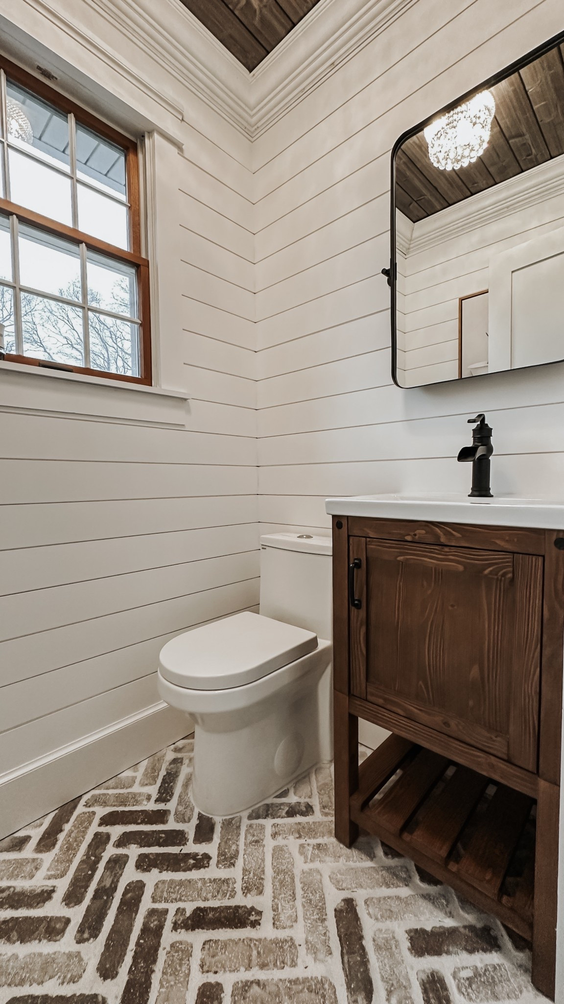 Bathroom inspiration: rustic herringbone brick flooring, charred shiplap, crystal flushmount light, farmhouse style vanity, faucet, mirror, space-saving toilet. Powder room decor.

#LTKSaleAlert #LTKFamily #LTKHome