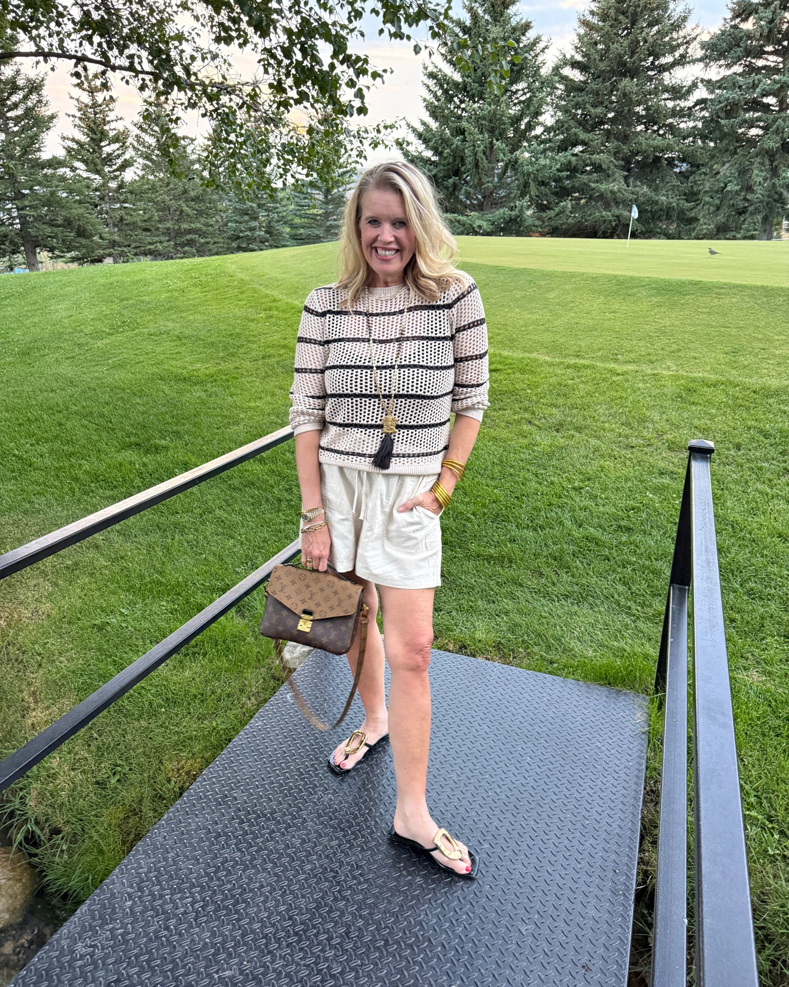 A perfect 70 degree Fall transition outfit✔️
(I wore on vacation to dinner) 

Shorts and a sweater 

Crochet  cream and black striped sweater (I have been using this a lot lately over my shoulders ) it’s a cute pop of texture and pattern 
Tts I am in a med 

Linen shorts with drawstring and elastic band with pockets 
Comfy and flowy wearing a med 

Lv bag (one of my favorites) it’s the perfect everyday size 

Pendant and tassel necklaces are so on trend and this one was vintage tassel I picked up years ago ( I’ll like something similar) 

Cute & statement making sandals gold embellishment sandals (these are identical to my Jeffery Cambell ones at a fraction of the price.  
I do have to say not as comfortable but if you’re a saving girl, highly worth it.

#LTKootd #LTKOver40 #LTKTravel