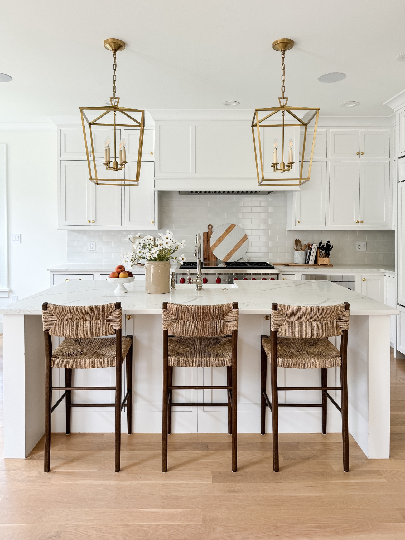 Shop our neutral, light and bright white and wood kitchen! Wall paint is Benjamin Moore Simply White. Cabinets are white from Mouser Cabinetry. Cabinet hardware is Aged Brass from Rejuvenation. Kitchen island pendants are the Visual Comfort Darlana Lanterns in the medium size, unburnished brass finish. Walnut and Woven Kitchen Counter Stools, Nancy Meyers Aesthetic, Serena and Lily, Modern Coastal Kitchen, Pure Salt Interiors, California Coastal, East Coast Traditional, Kitchen design, Kitchen Island Lighting, Kitchen Decor, Minimalist, Look for Less, Amazon Home Finds, Kitchen Island Styling, World Market Finds, Target Finds

#LTKFindsUnder100 #LTKStyleTip #LTKHome