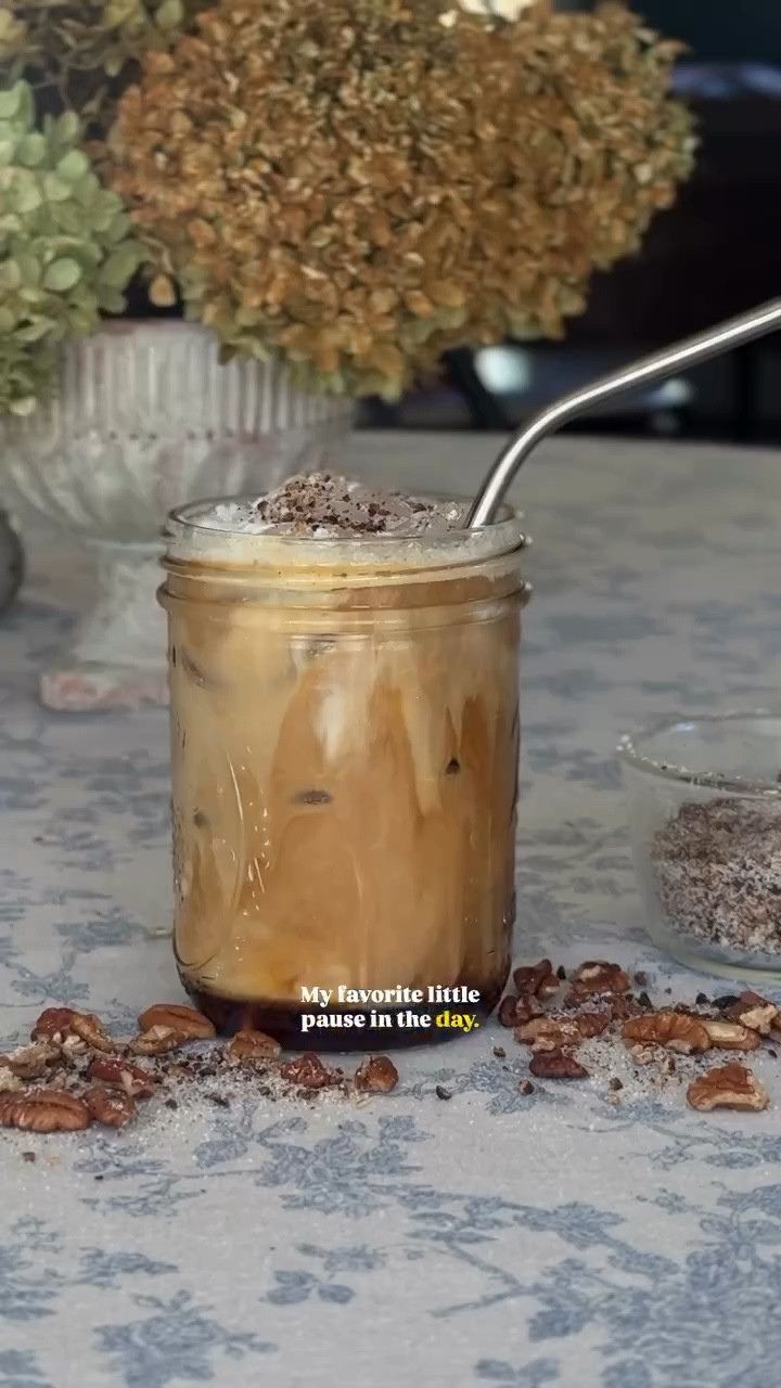 Welcome to The Afternoon Pour. Today I’m making a twist on the @starbucks iced pecan crunch latte, using coconut milk for a dairy-free treat. But if you haven’t tried their version before, you should check it out first! It’s delicious!

Big thanks to @nespresso for helping me pull the perfect shot of espresso at home — it’s the foundation of this little indulgence!

☕ The Afternoon Pour | Iced Pecan Crunch Latte (with Coconut Milk) Recipe:

For the Pecan Syrup:
•In a small saucepan, combine 1 cup sugar,1 cup water, and 3/4 cup chopped pecans.

•Bring to a light simmer, stirring until the sugar dissolves.
•Let it bubble gently for 3–4 minutes, then remove from heat and let steep about 10 minutes.

•Strain out the pecans and pour the syrup into a jar. (Keeps in the fridge for up to a week!)

To Assemble the Drink:
•Brew a strong shot of espresso using your @nespresso (or any espresso maker) and let it cool slightly.

•Fill a glass with ice, then add 1–1½ oz of pecan syrup.
Pour in your cooled espresso.

•Top with 6 oz coconut milk and give it a gentle stir.
For that signature creamy finish, whisk together a little coconut milk + splash of vanilla + drizzle of syrup to make a light foam. Spoon it over the top.

•Finish with a sprinkle of crushed toasted pecans + brown sugar for that “pecan crunch” magic.

LIKE & SAVE this recipe for your future 2pm pick me ups!

-

#TheAfternoonPour #KindredHomestead #CoffeeAt2 #HomeCafeVibes #HomemadeLatte #CoffeeLover #NespressoRecipes #NespressoMoments #IcedLatteSeason #FallCoffeeDrinks #CozyAfternoons #SlowLiving #IntentionalHome #AfternoonRitual #HomeBarista #DailyRituals #CoconutMilkLatte #PecanLatte #MadeAtHome #CoffeeTime