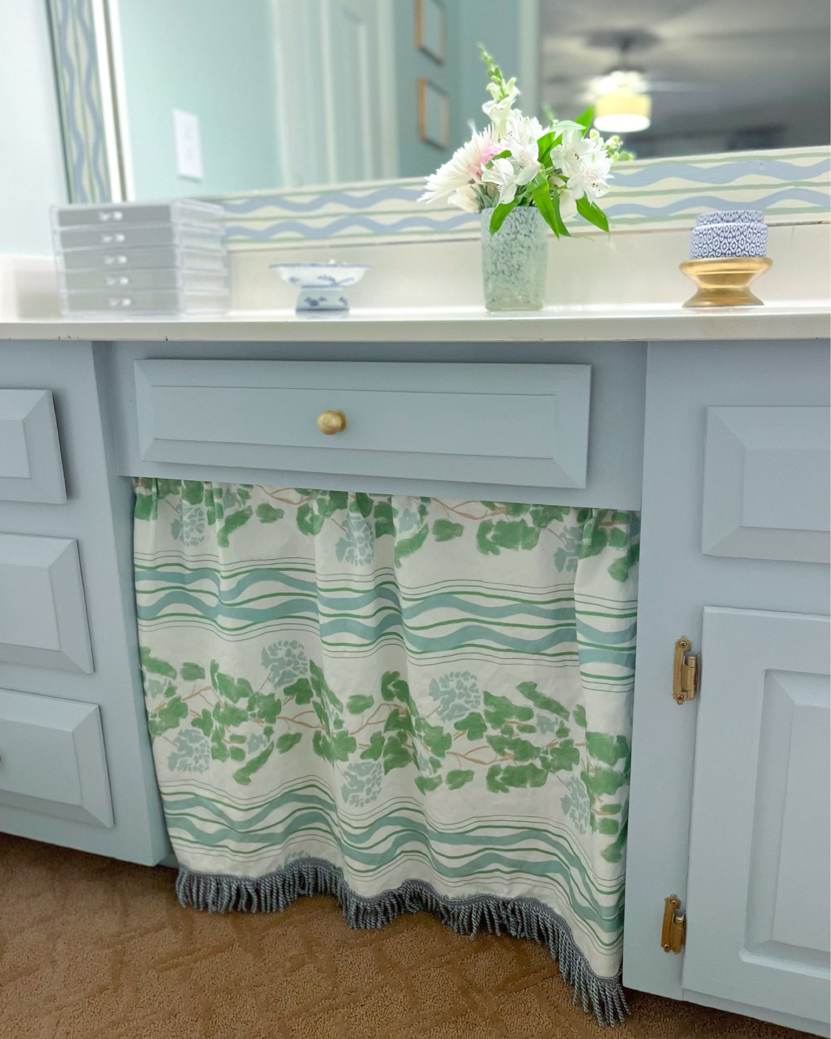 We have an 80s style bathroom vanity, open to our bedroom, so refreshing the space with new color, fabric, and accessories helped make the space more cohesive and match my style. Fabric is Lulie Wallace, which you can order from her site or I believe through Wheaton Whaley.

#LTKhome