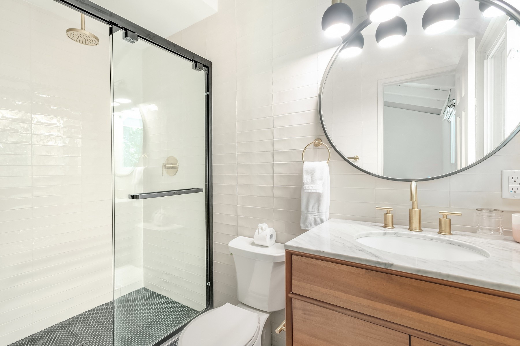 One of my favorite timeless bathroom styles is to mix black, wood & cream. The oversized Home Depot vanilla tile on the walls and wood vanity warm up the black floor tile and shower frame. Linked exact and similar finds below.

#LTKHome #LTKSaleAlert