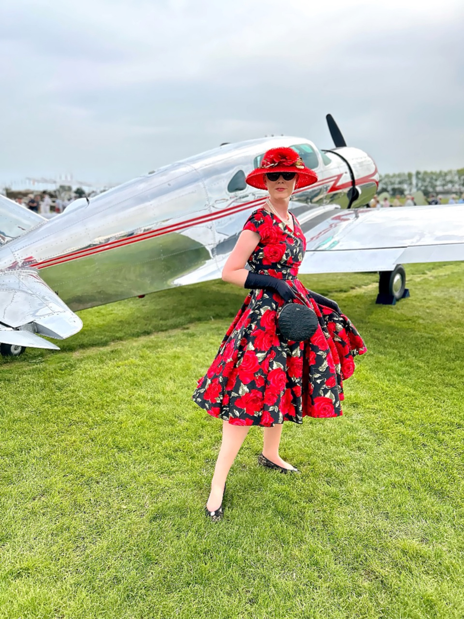 I can’t wait for Goodwood Revival! An event where everyone dresses up in styles from the stylish 1940s, 1950s and 1960s. Naturally this is a 1950s inspired look, with a fab red rose print dress and petticoat underneath the full circle skirt. I partnered with black lace ballerina flats by Pretty Ballerinas, Cats Eye sunglasses by Kate Spade New York, black mid forearm gloves by Dents, a red rose hat I bought some years ago from Grevi a renowned milliner based in Florence, Italy, and finally a hat box style vegan leather bag with my initials from LRM. Hope this gives you inspo if you’re off to Goodwood Revival 🌹 

#LTKuk #LTKsummer #LTKstyletip