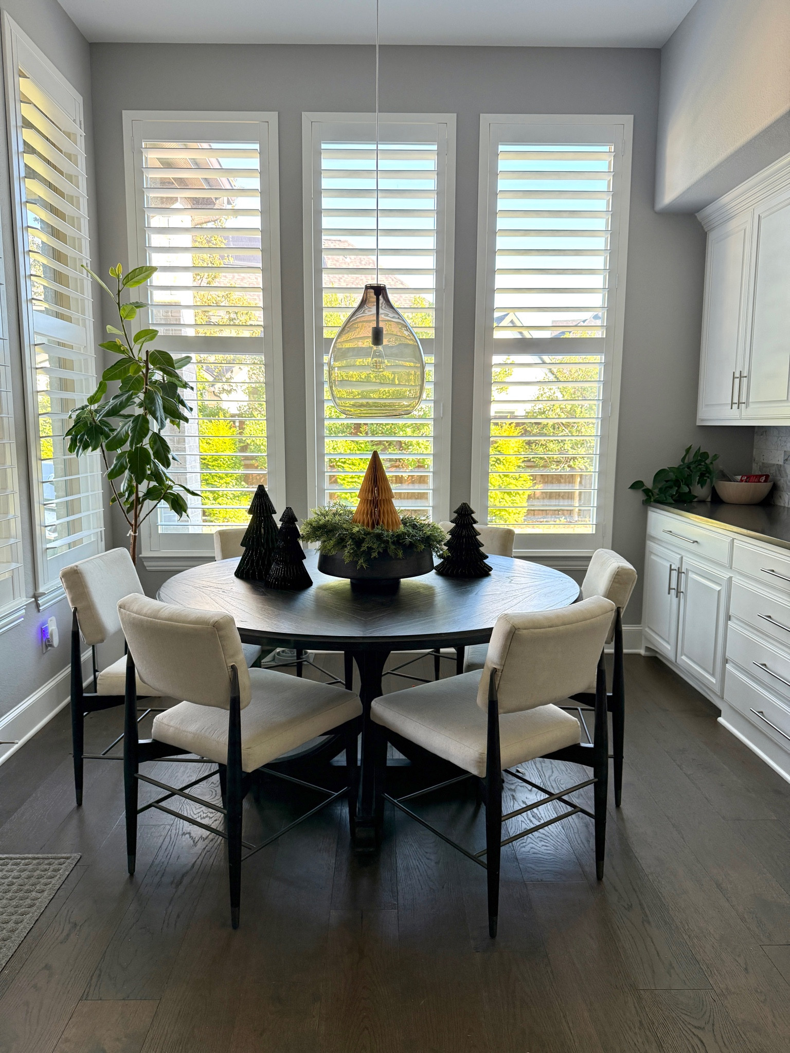 Simple Christmas styling on kitchen table! I set an old wreath over my favorite wooden bowl and put a paper tree on top! 

#LTKSeasonal #LTKHoliday #LTKHome